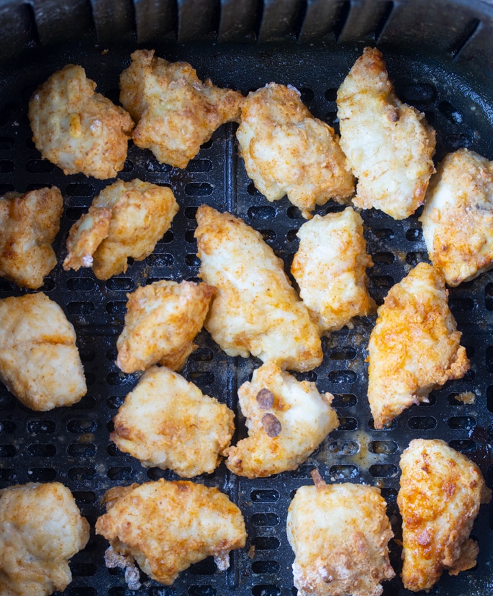 cooked chicken pieces in air fryer basket