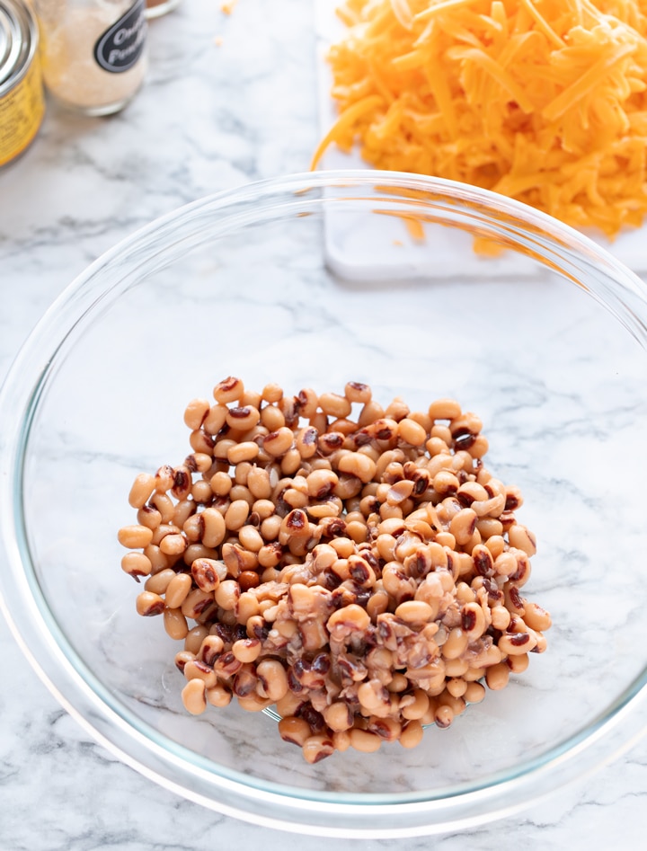 black eyed peas in large bowl with cheese in background