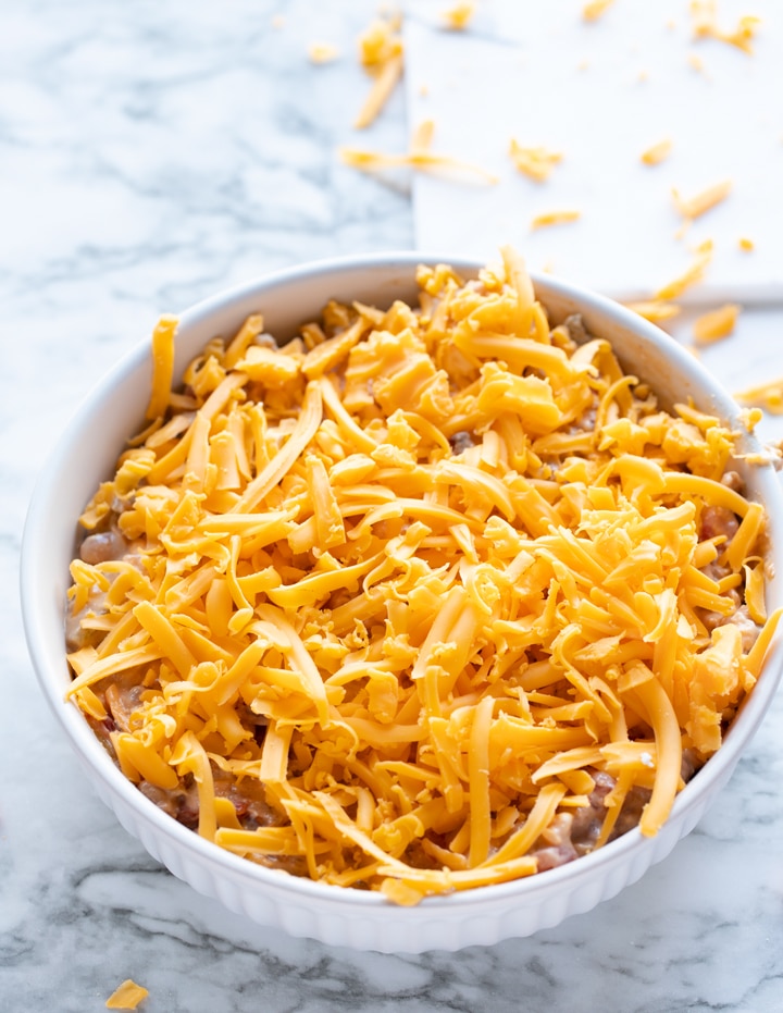 black eyed pea dip in baking dish covered with cheese