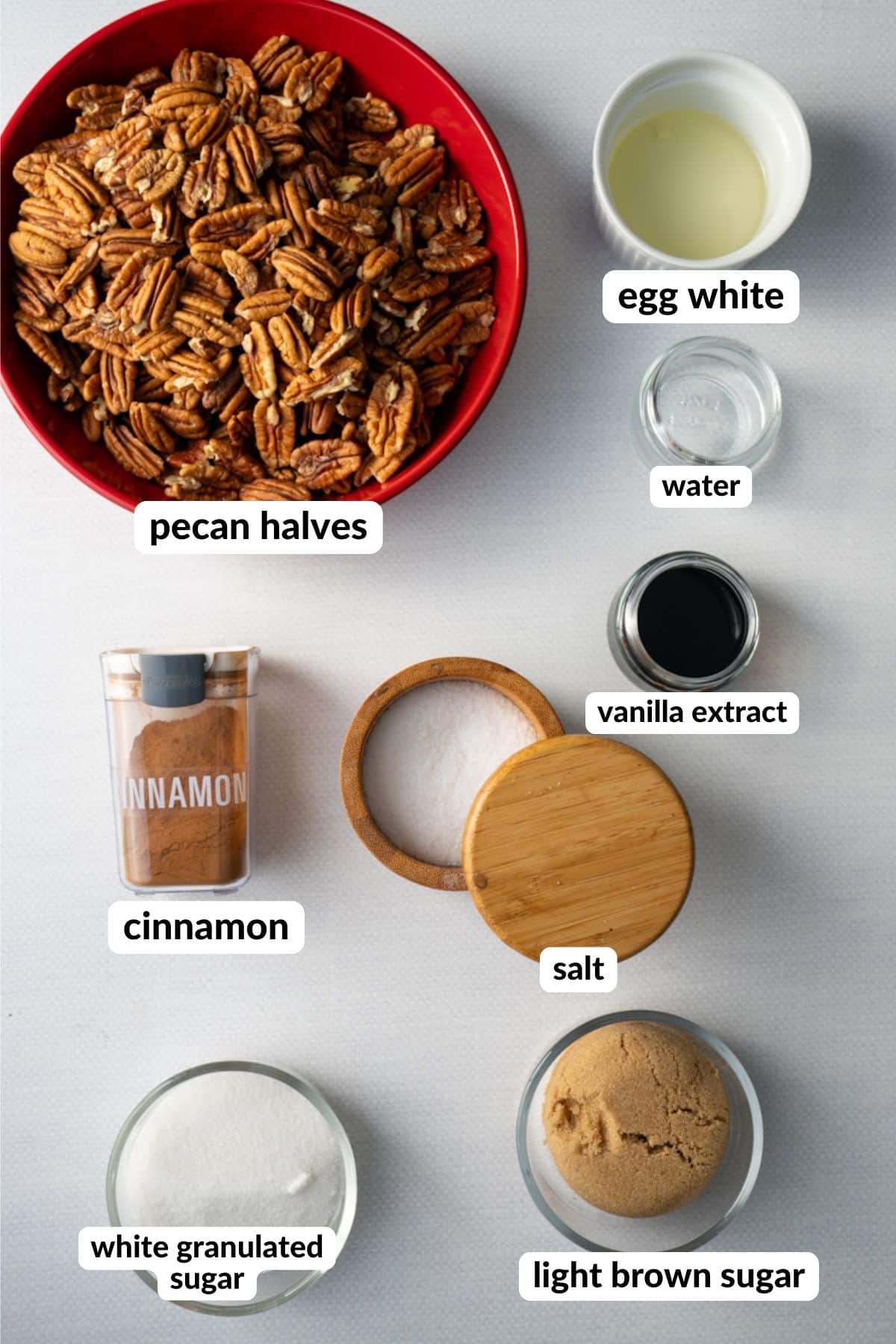 ingredients for cinnamon sugared pecans on table with labels
