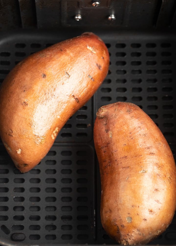 raw sweet potatoes in air fryer basket