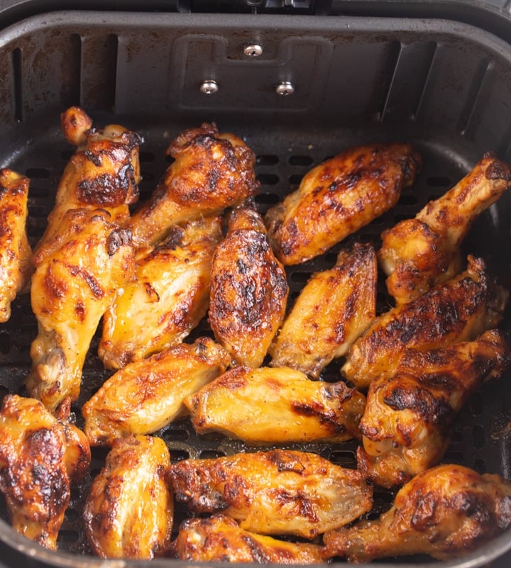 charred wings in air fryer basket