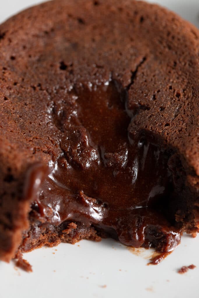 close up photo of molten lava cake and the chocolate puring out