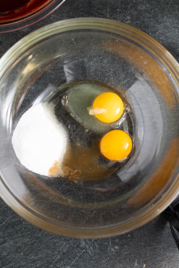 eggs and sugar in glass bowl