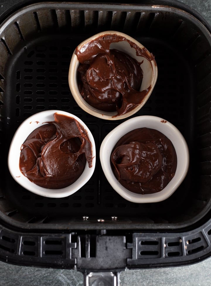 chocolate mixture in ramekins in air fryer basket