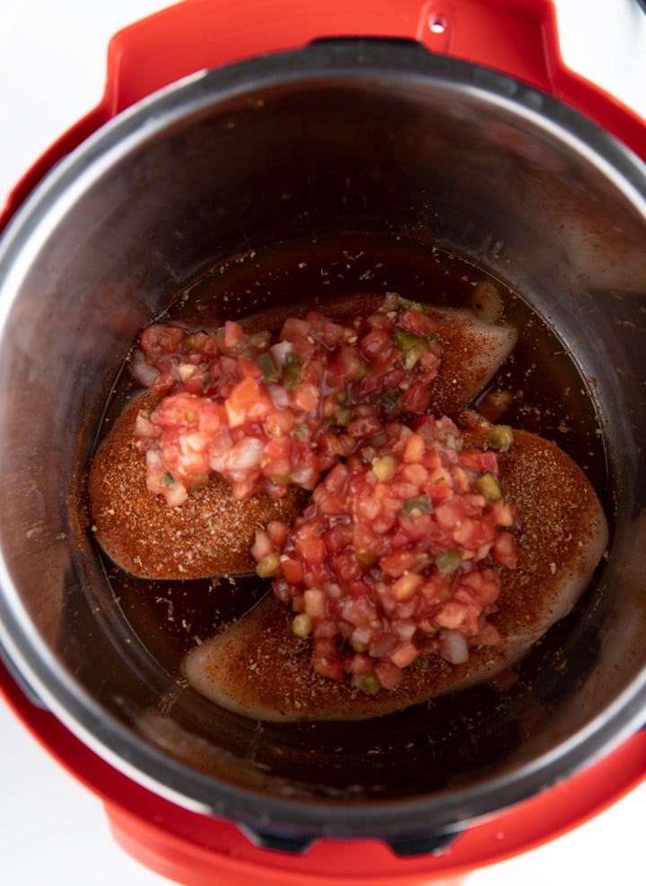 chicken in instant pot with salsa on top