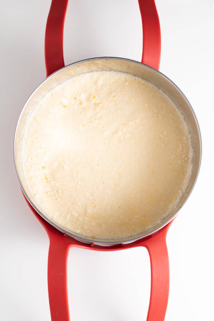 lemon curd mixture in stainless steel bowl on oxo bakeware sling