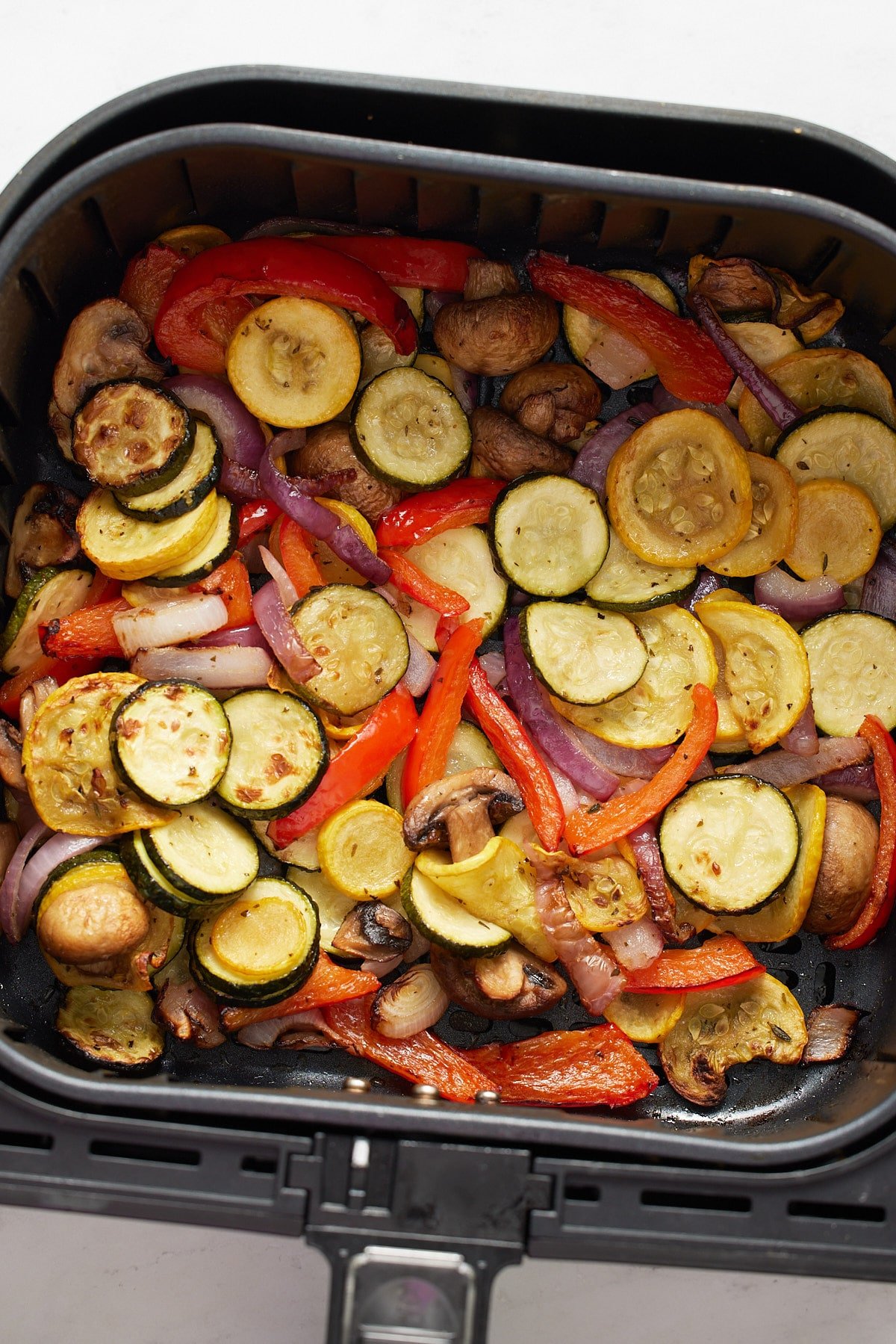 The cooked marinated vegetables in the air fryer basket