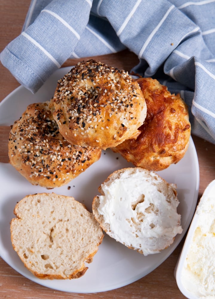 bagels on a plate with a blue towel around them