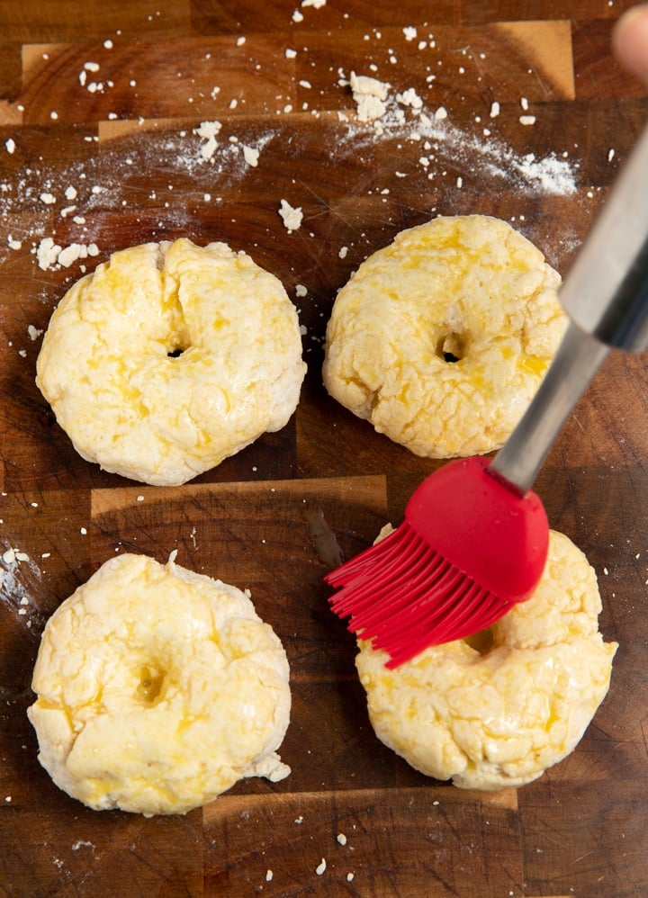 pastry brush putting egg wash on bagel