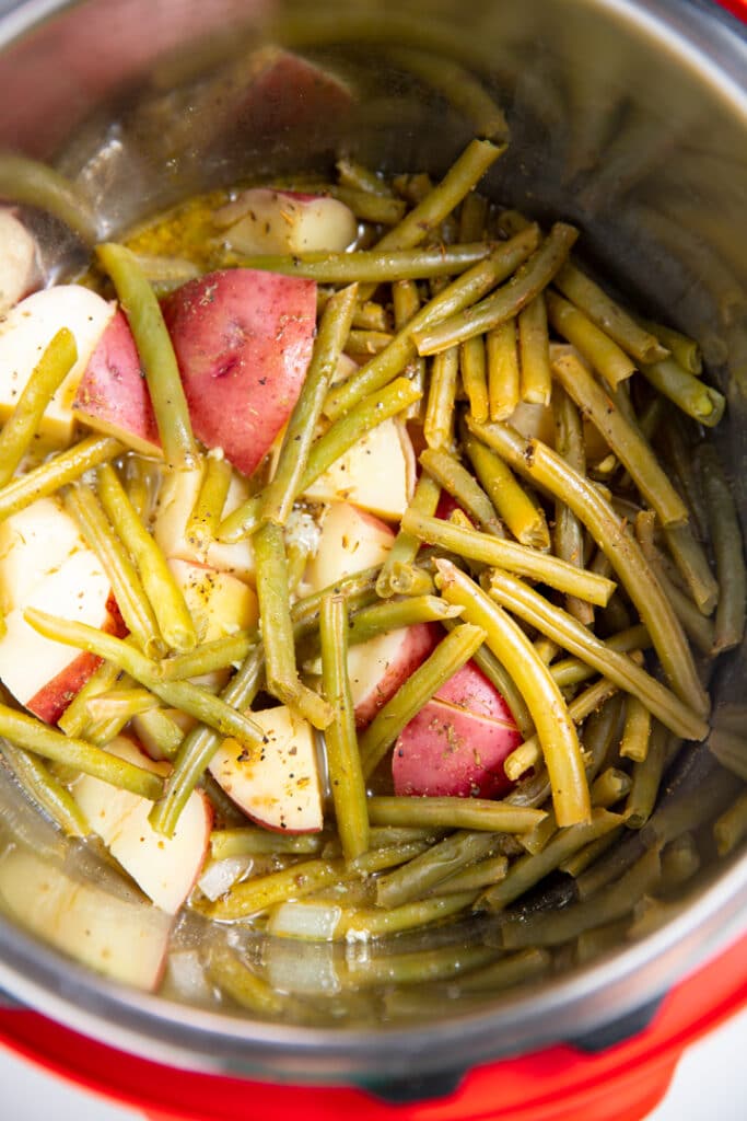 The cooked green beans and potatoes in the Instant Pot