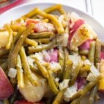 Instant pot green beans and potatoes served on a white plate