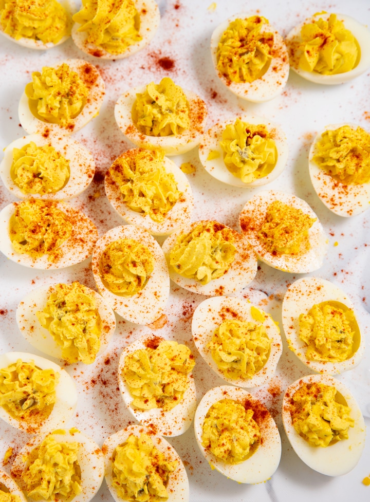 Southern deviled eggs ready to eat with a sprinkling of paprika