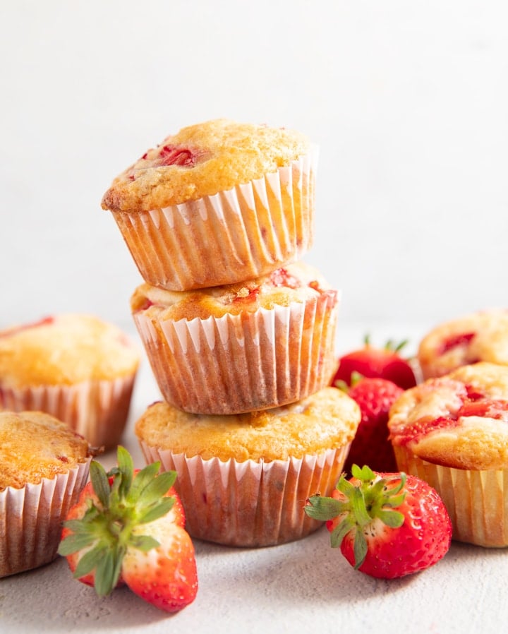 Three strawberry muffins stacked on top of each other