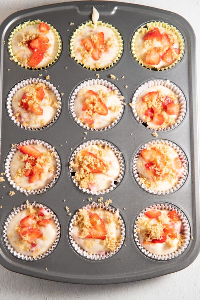 The strawberry muffin mixture in a muffin tin