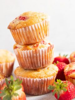 Three strawberry muffins stacked on top of each other