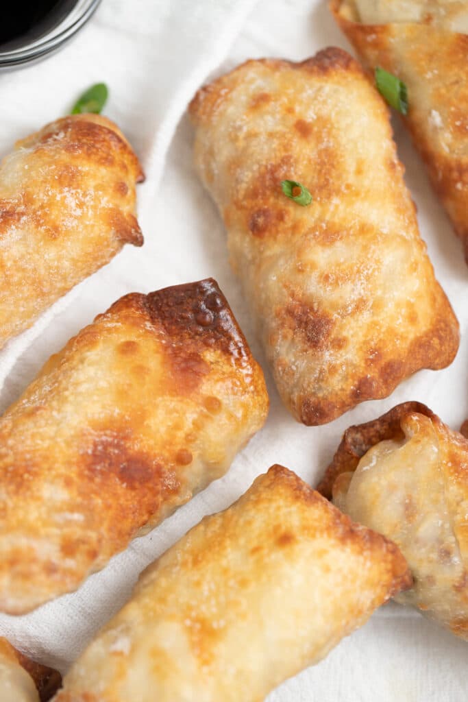 Close up of air fryer egg rolls on a white plate