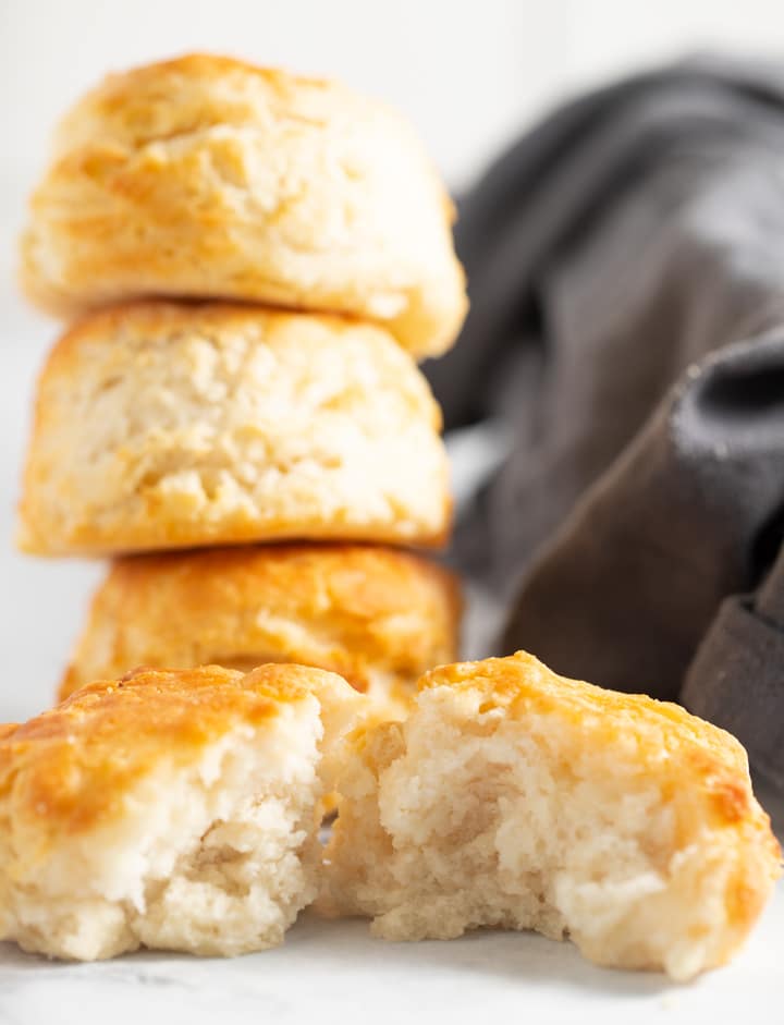 air fryer biscuits stacked on top of each other with one broken open