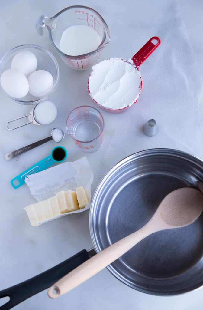 Ingredients to make the churros and a saucepan and wooden spoon