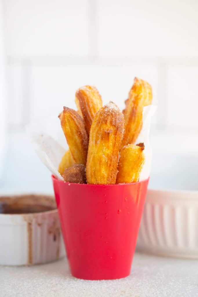 Homemade churros in a red cup