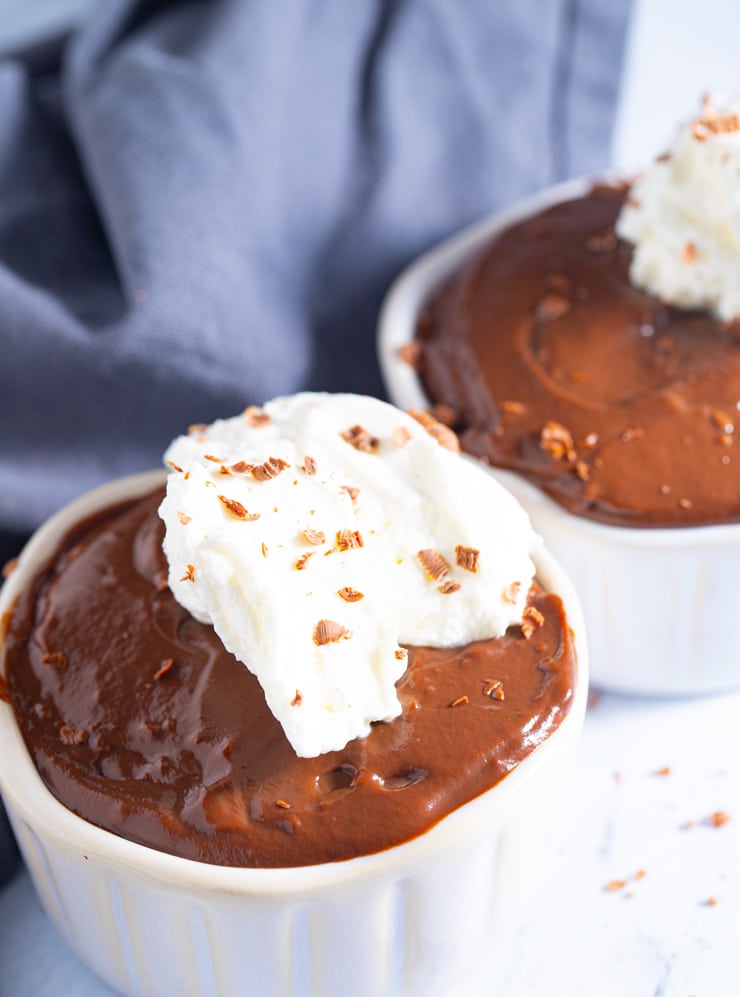 Homemade chocolate pudding topped with cream