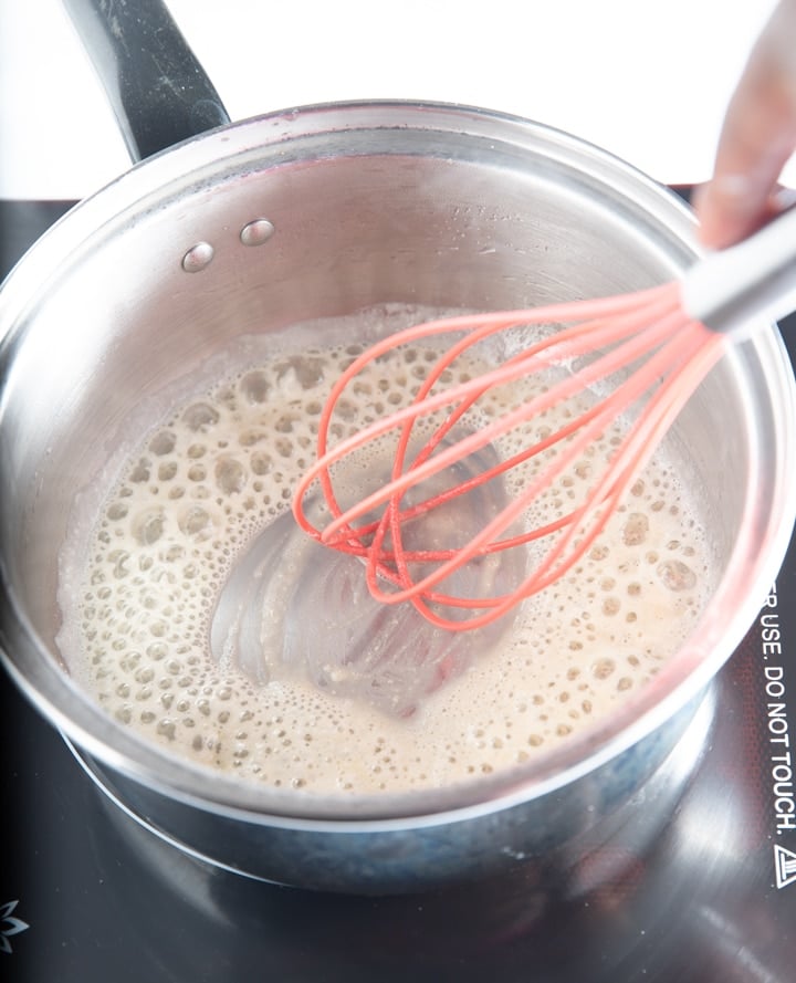 Whisking ingredients in a pan