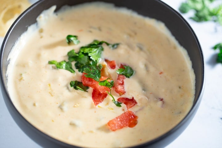 Queso dip in a black bowl