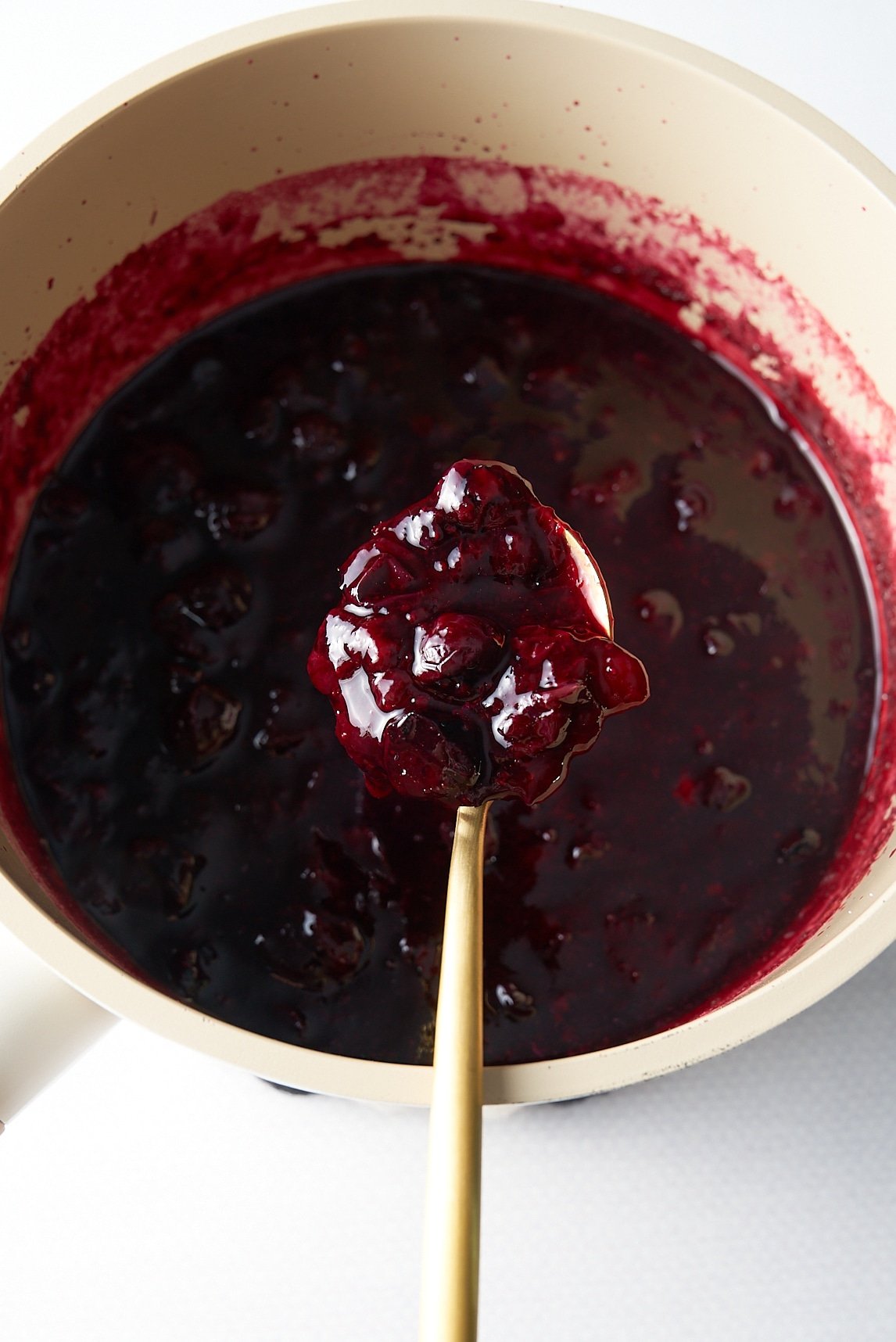 blueberry compote in pot and picked up with spoon