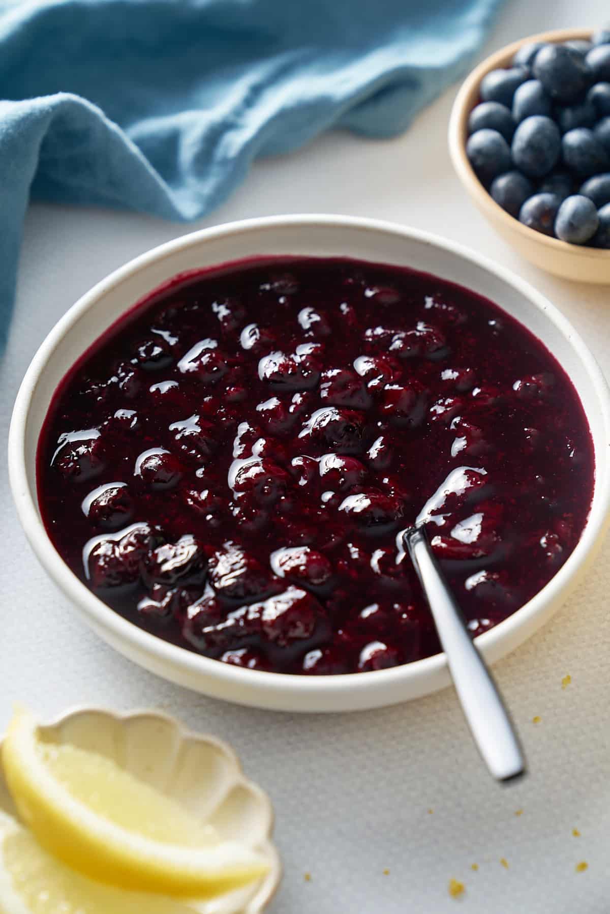 blueberry compote with plate with spoon in the middle