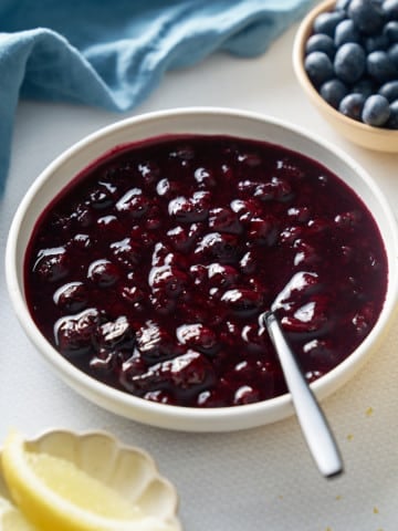 blueberry compote with plate with spoon in the middle