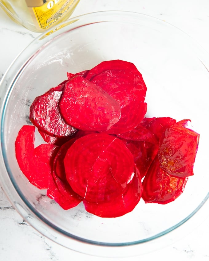 beets in a glass bowl covered in olive oil