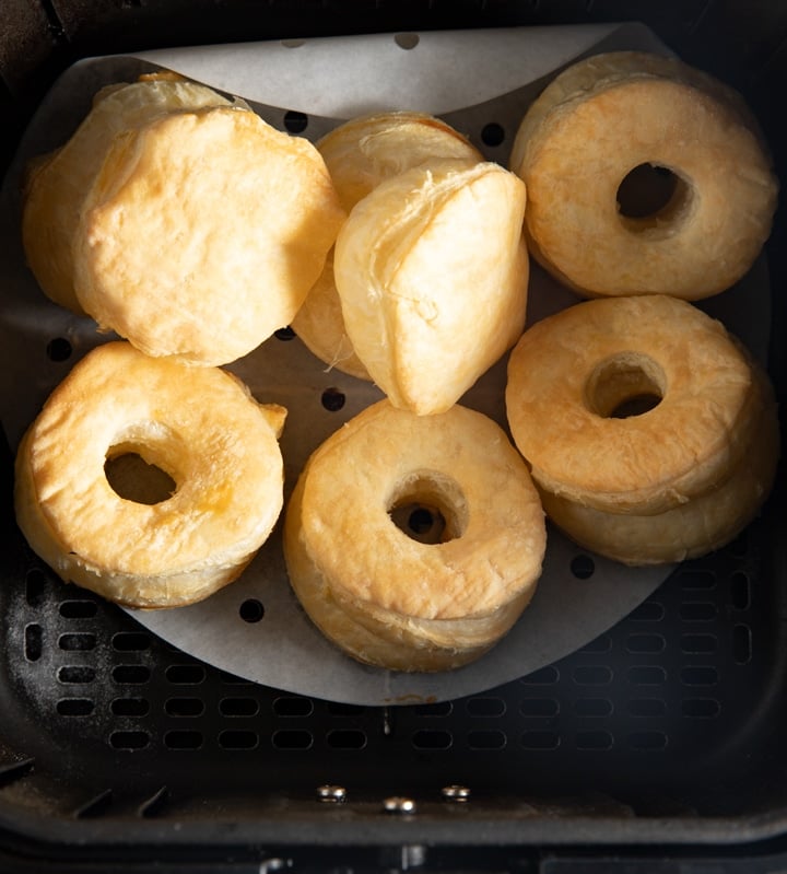 The cooked donuts in the air fryer basket