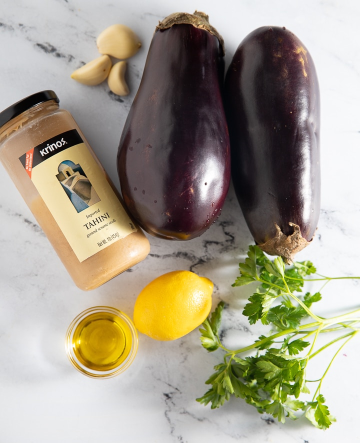 Ingredients to make baba ghanoush on a marble work top