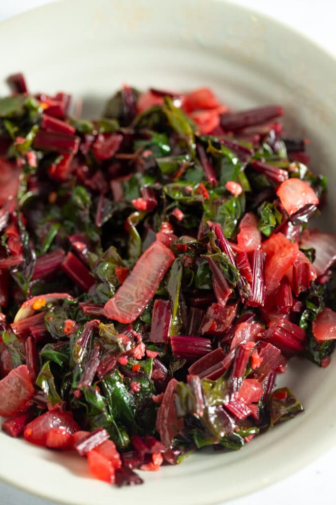 Beet greens served in a white bowl