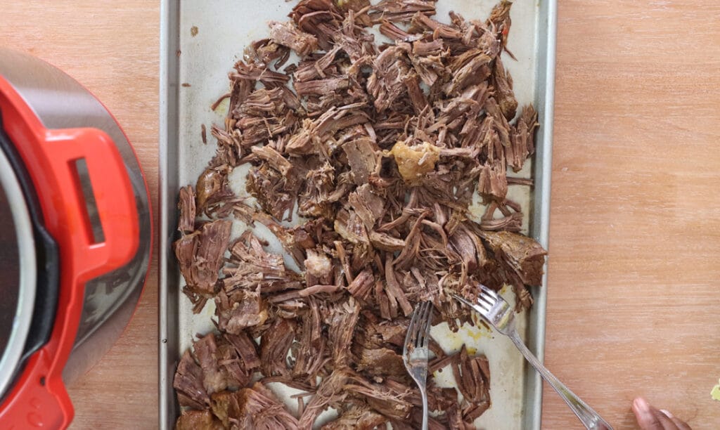 Shredded Italian beef on a baking sheet