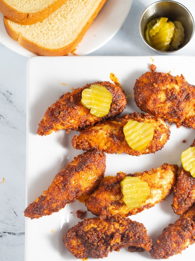 nashville hot chicken tenders on a white plate