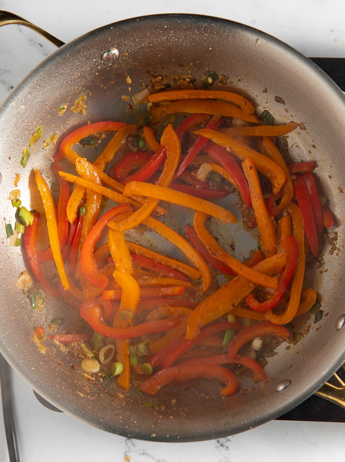 Bell peppers added to the pan