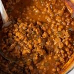 beans in pot with spoon taking it out