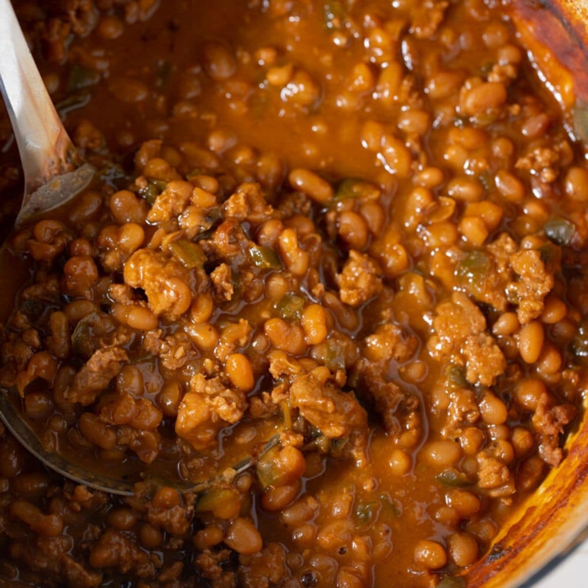 beans in pot with spoon taking it out