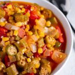 Stewd okra and tomatoes in a white bowl