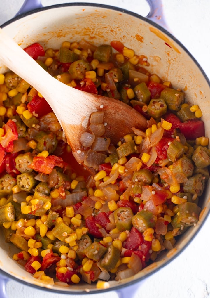 A spoon stirring the ingredients in a pot