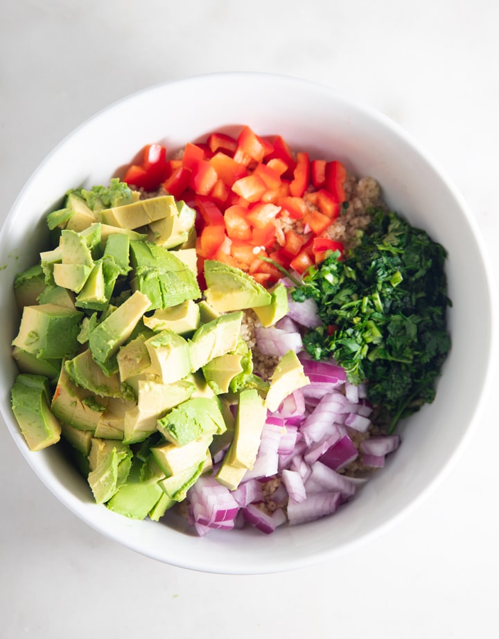 The salad ingredients in a white bowl