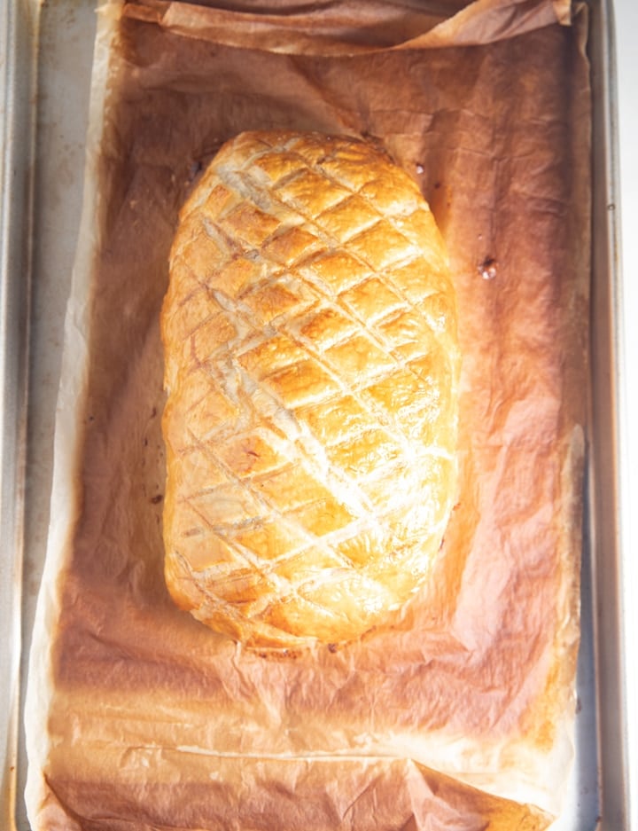 The cooked salmon wellington on a chopping board