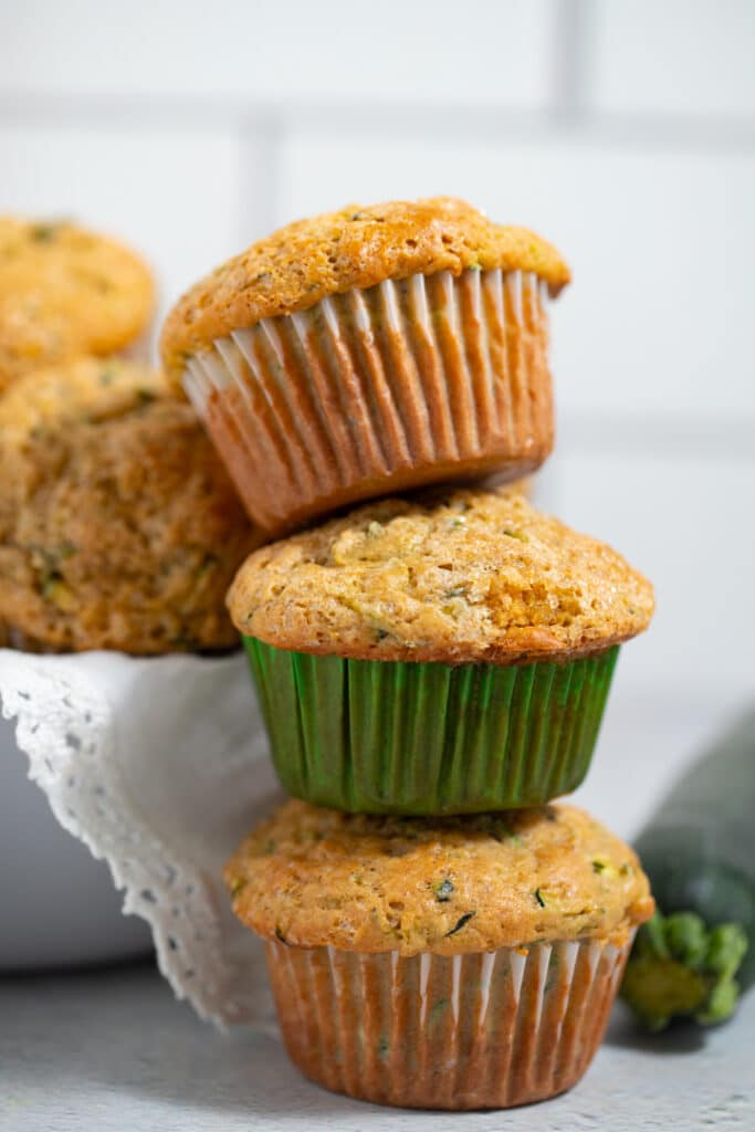 Three zucchini muffins stacked on top of each other