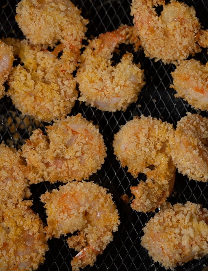 Close up of the shrimp in an air fryer basket