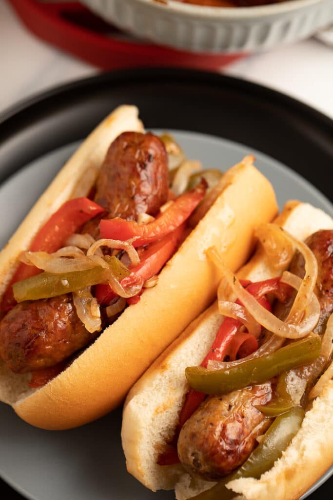 Air fried sausages and vegetables in buns on a plate