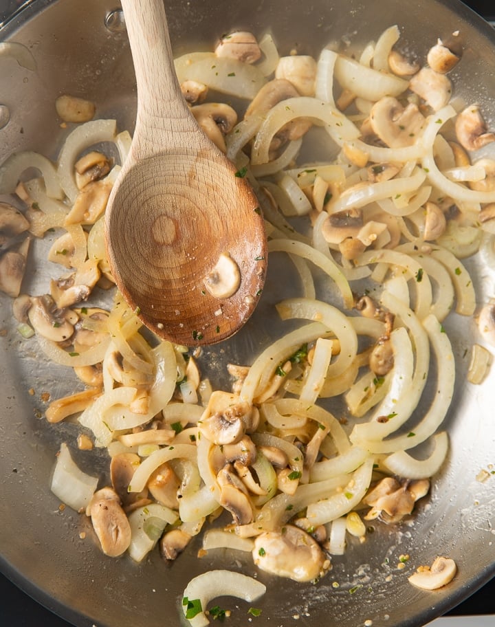 Frying onions and mushrooms in a pan