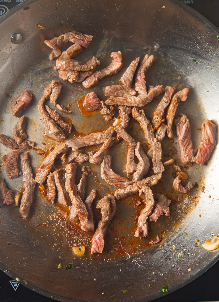 Steak frying in a pan