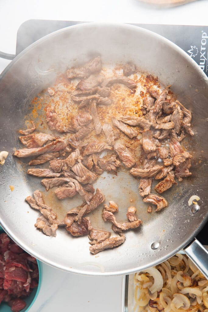 Mushrooms cooking in a pan