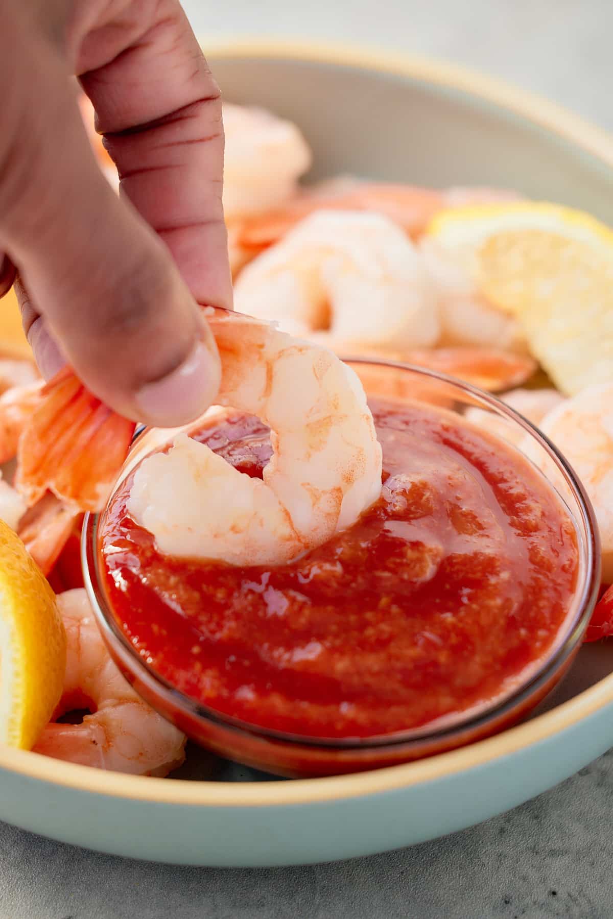 The sauce in a bowl next to fried shrimp